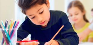 niña escribiendo en la sala de clases